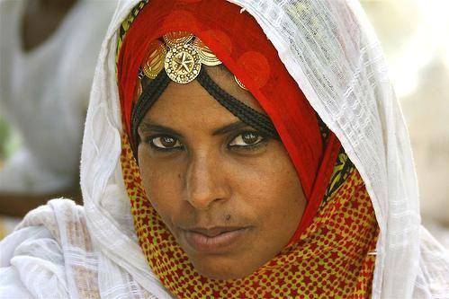 Rashaida woman with red headscarf and gold jewelry
